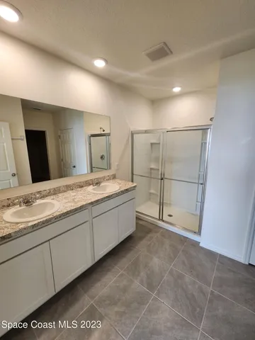 a bathroom with a granite countertop sink a toilet and mirror