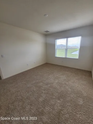 an empty room with a windows