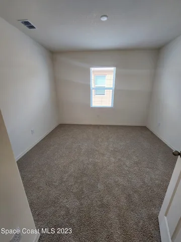 an empty room with a empty space and a window