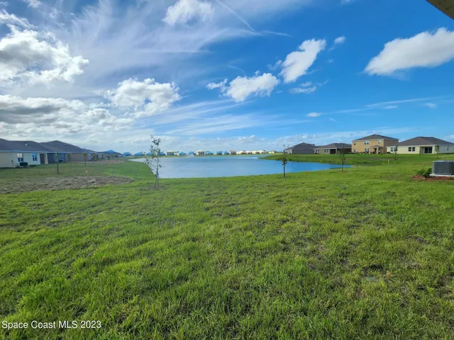 a view of a big yard with lots of green space