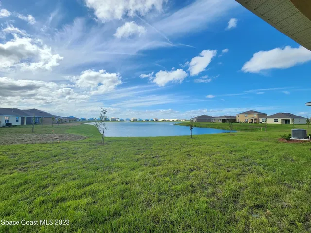 a view of a big yard with lots of green space