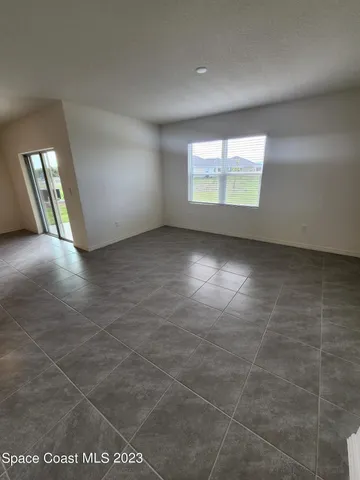 an empty room with windows and entrance