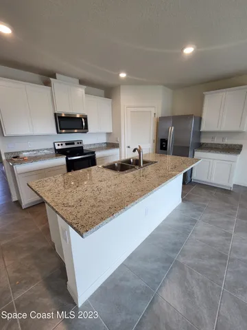 a kitchen with kitchen island granite countertop a sink and counter space