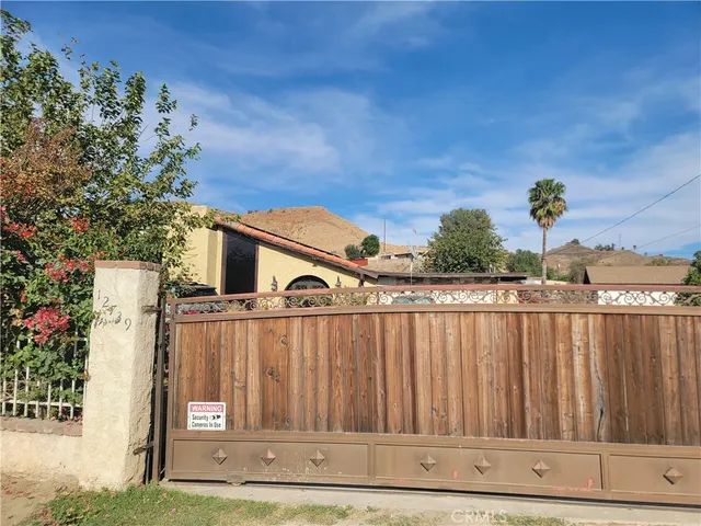 a view of a house with wooden fence