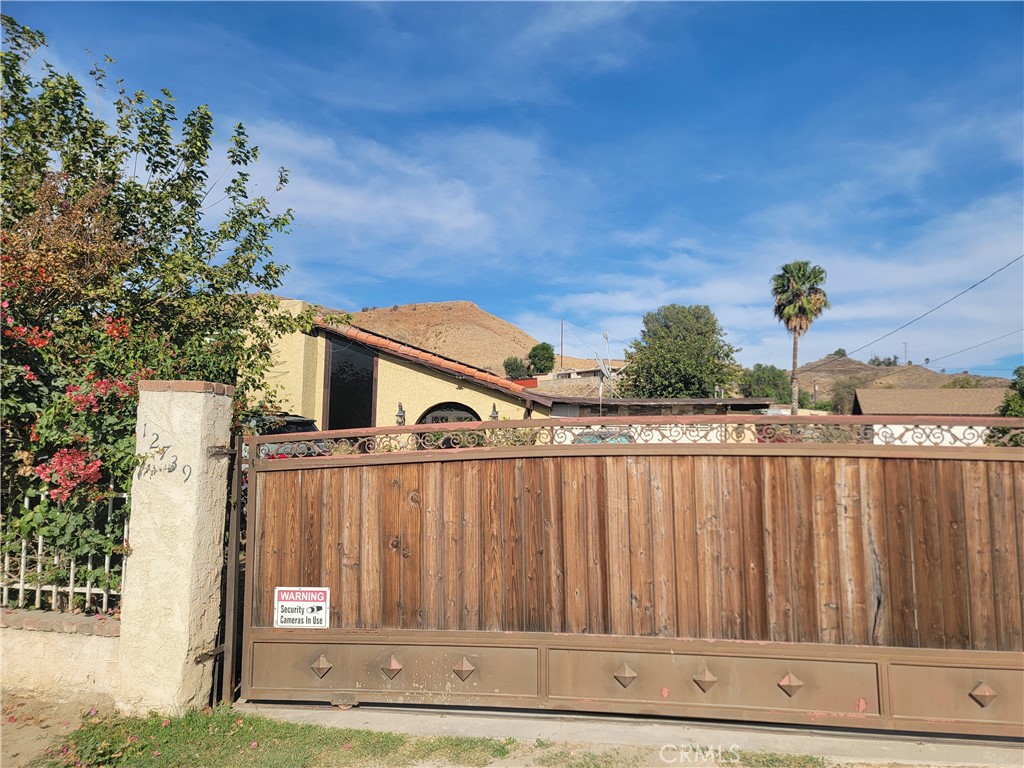 a view of a house with wooden fence
