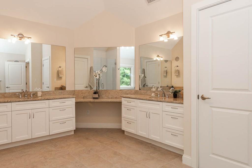 43 Beaver Pond Road Beverly, MA 01915 - Photo 19 of 33 a bathroom with a granite countertop double vanity sink a mirror and a bathtub
