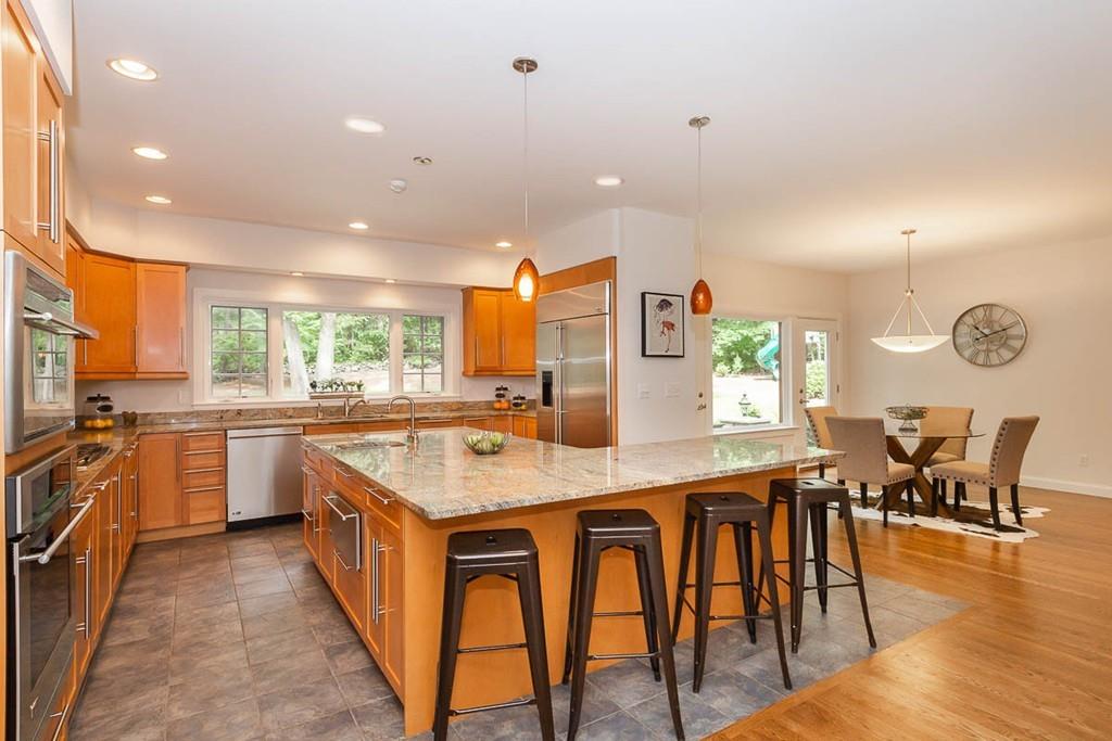 43 Beaver Pond Road Beverly, MA 01915 - Photo 6 of 33 a kitchen with stainless steel appliances granite countertop table chairs and a refrigerator