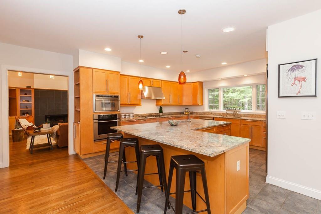 43 Beaver Pond Road Beverly, MA 01915 - Photo 8 of 33 a kitchen with stainless steel appliances granite countertop sink stove and wooden cabinets