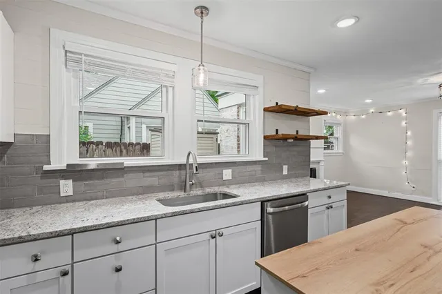 a kitchen with a sink cabinets and window
