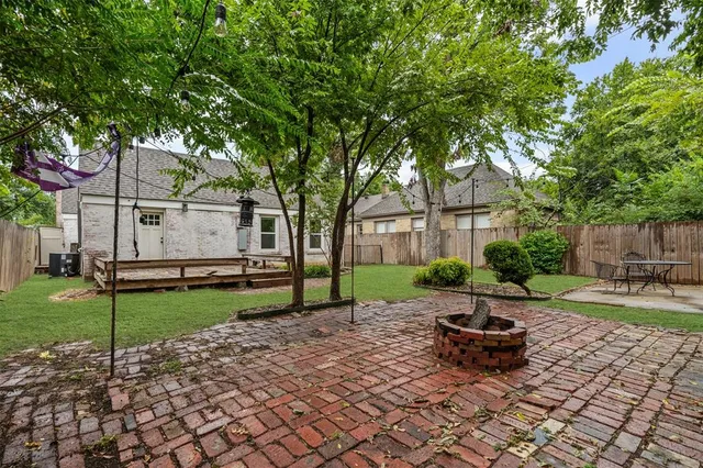 a wooden bench sitting in middle of the yard