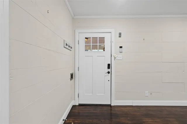 a view of a hallway with wooden floor and closet area