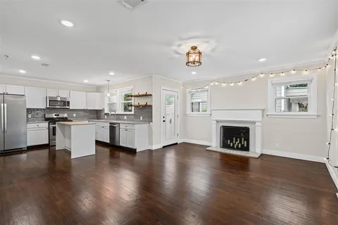 an open kitchen with white cabinets and stainless steel appliances