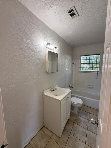 a bathroom with a sink toilet and mirror
