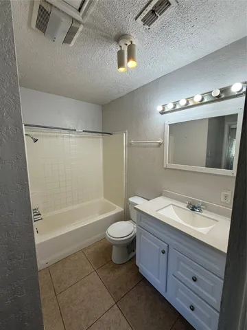 a bathroom with a double vanity sink toilet mirror and bathtub
