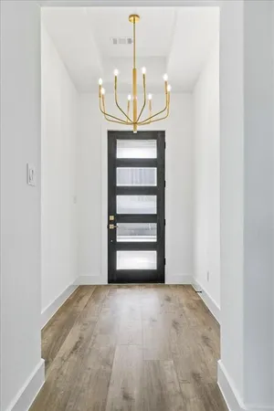 a view of room with staircase and a chandelier