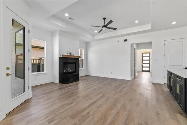 a view of a livingroom with a ceiling fan hardwood floor and a ceiling fan
