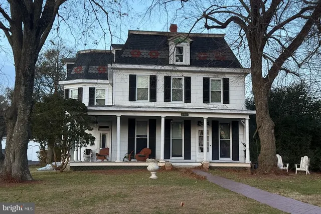 front view of a brick house with a yard