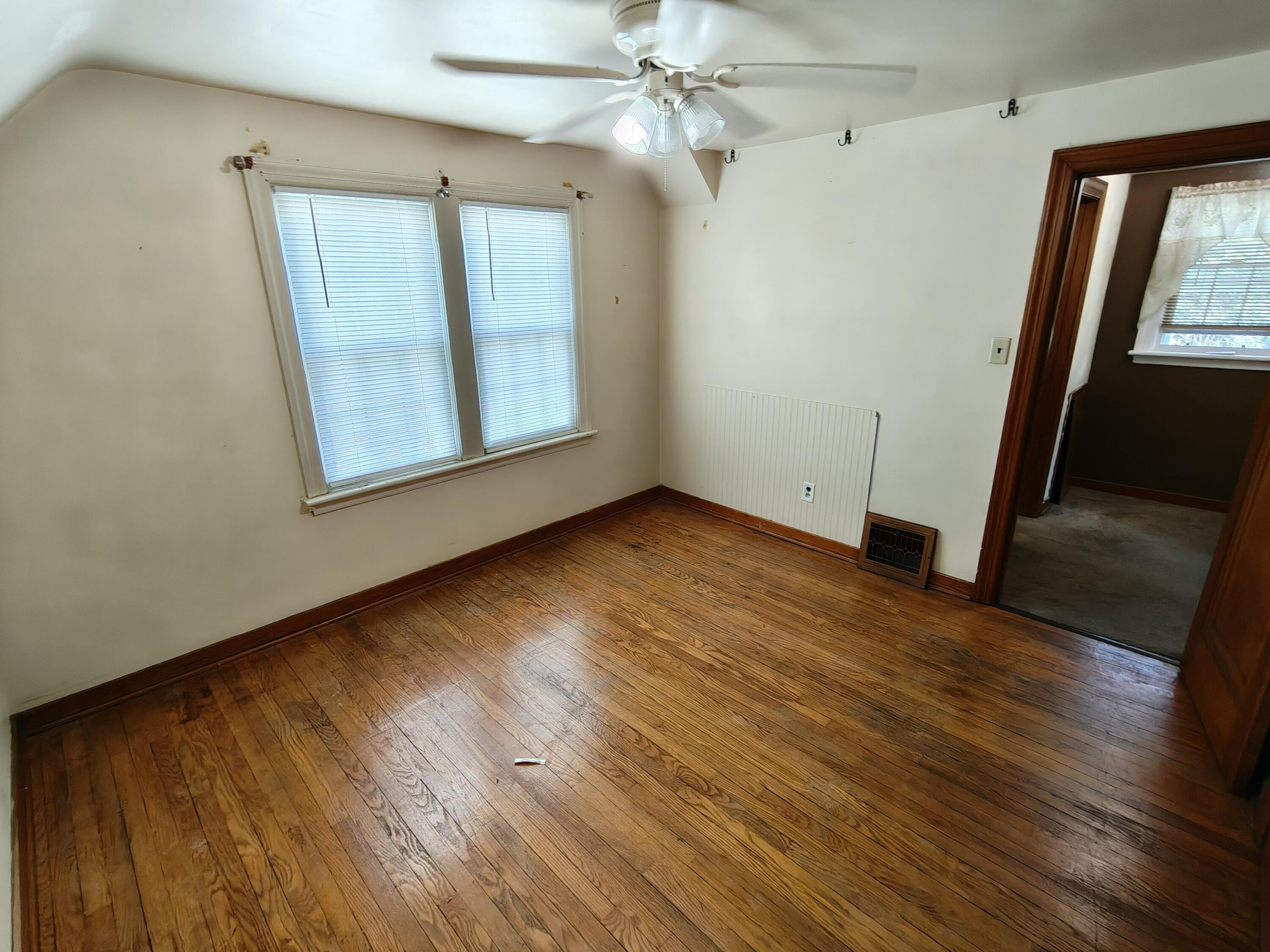 245 North Indiana Street Griffith, IN 46319 - Photo 16 of 30 a view of an empty room with wooden floor and a window