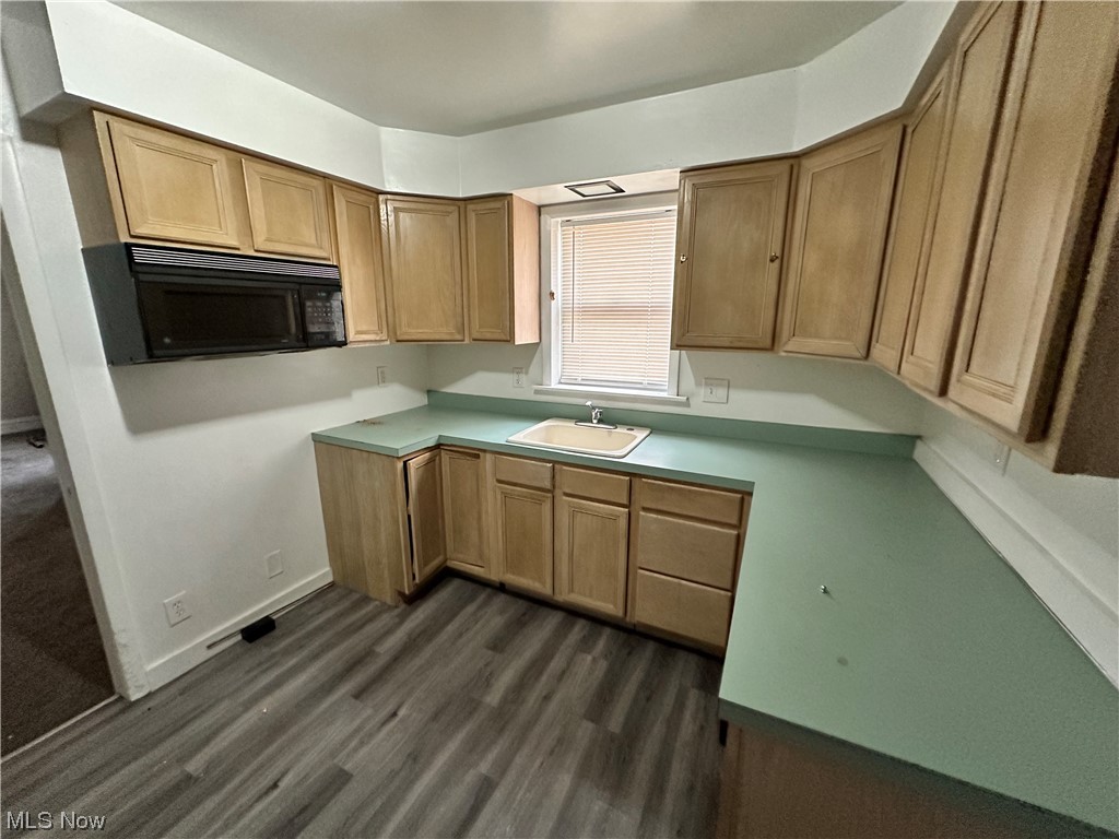 6734 Ottawa Road Cleveland, OH 44105 - Photo 6 of 31 Kitchen with sink and dark wood-type flooring