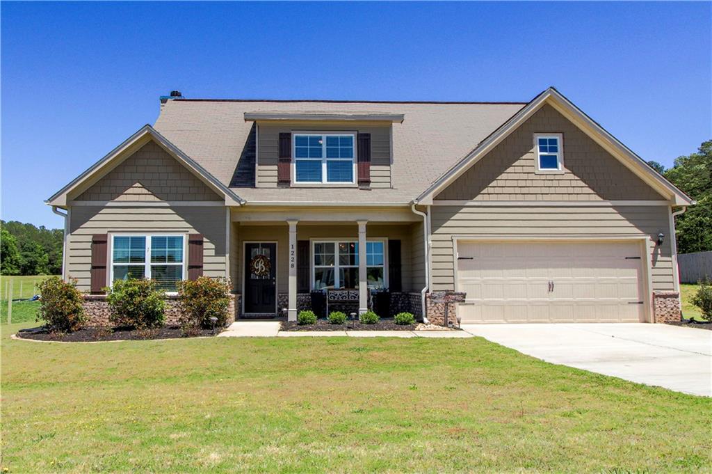 1228 Foster Road Statham, GA 30666 - Photo 1 of 1 a front view of a house with garden