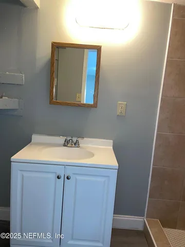 a bathroom with a sink and vanity