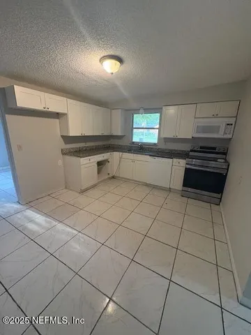 a kitchen with a sink and a stove top oven