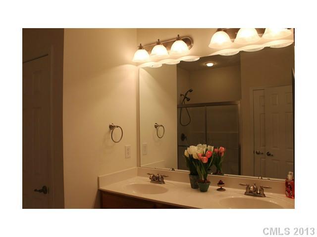 332 Garnet Court, Unit 528 Fort Mill, SC 29708 - Photo 12 of 16 a bathroom with a sink mirror and vanity