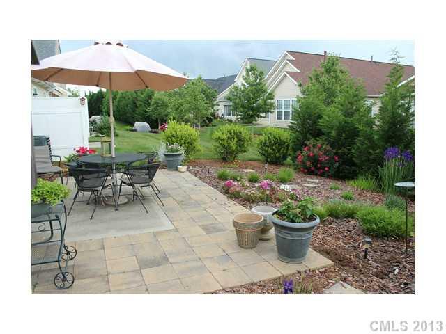 332 Garnet Court, Unit 528 Fort Mill, SC 29708 - Photo 15 of 16 a view of a patio with furniture and a garden