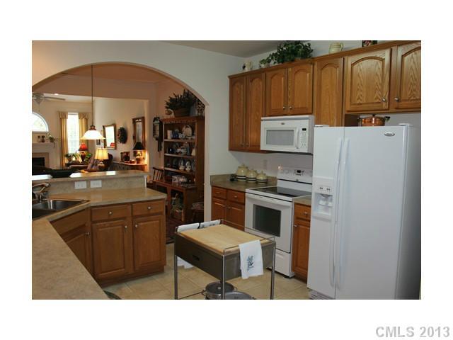 332 Garnet Court, Unit 528 Fort Mill, SC 29708 - Photo 3 of 16 a kitchen with stainless steel appliances a stove refrigerator and a microwave oven