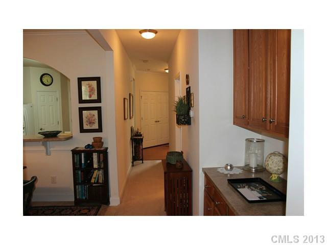 332 Garnet Court, Unit 528 Fort Mill, SC 29708 - Photo 9 of 16 a kitchen with stainless steel appliances kitchen island granite countertop a refrigerator a stove and a sink with wooden floor