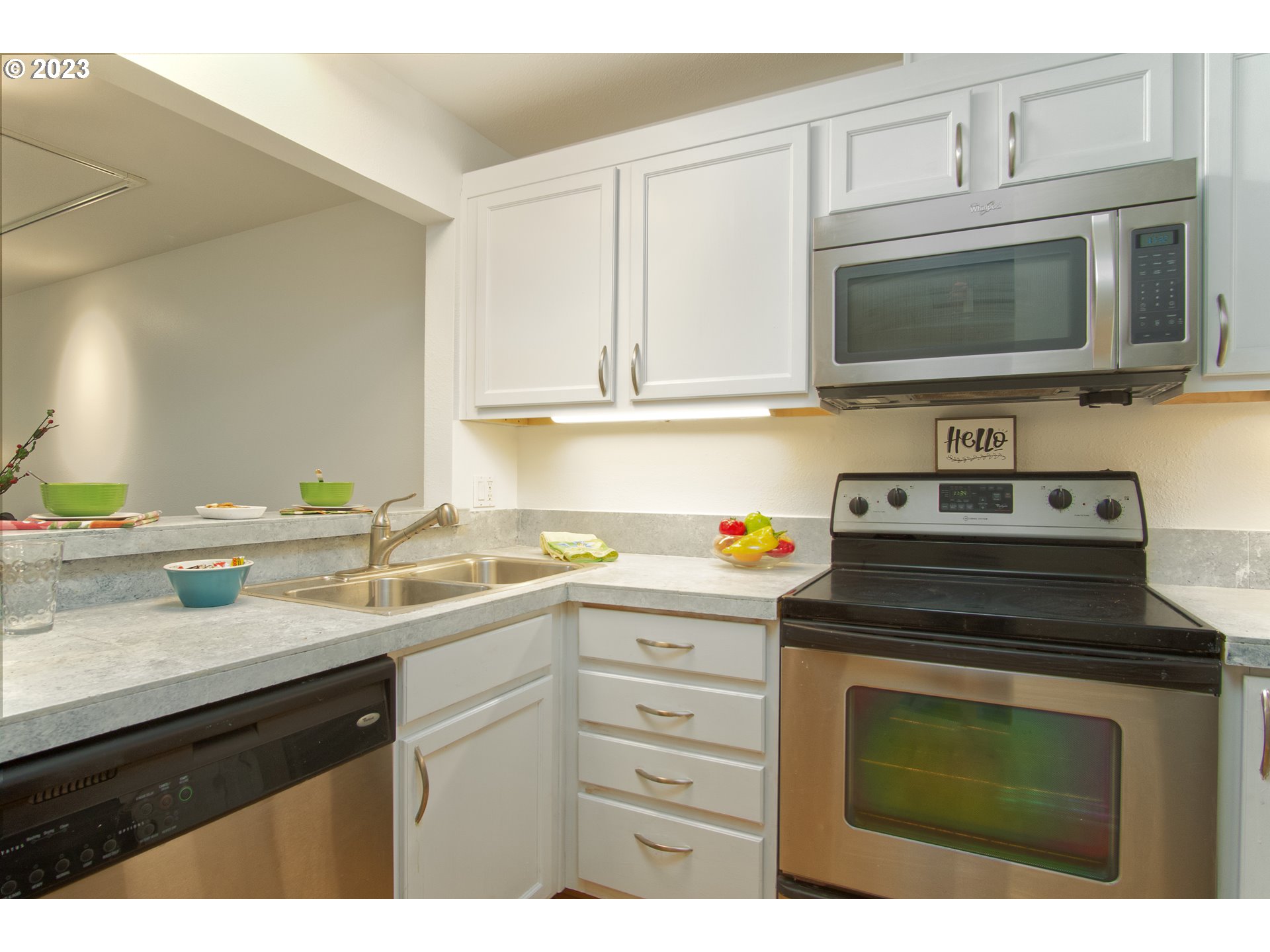 1500 Southwest Park Avenue, Unit 118 Portland, OR 97201 - Photo 7 of 30 a kitchen with cabinets stainless steel appliances and a sink