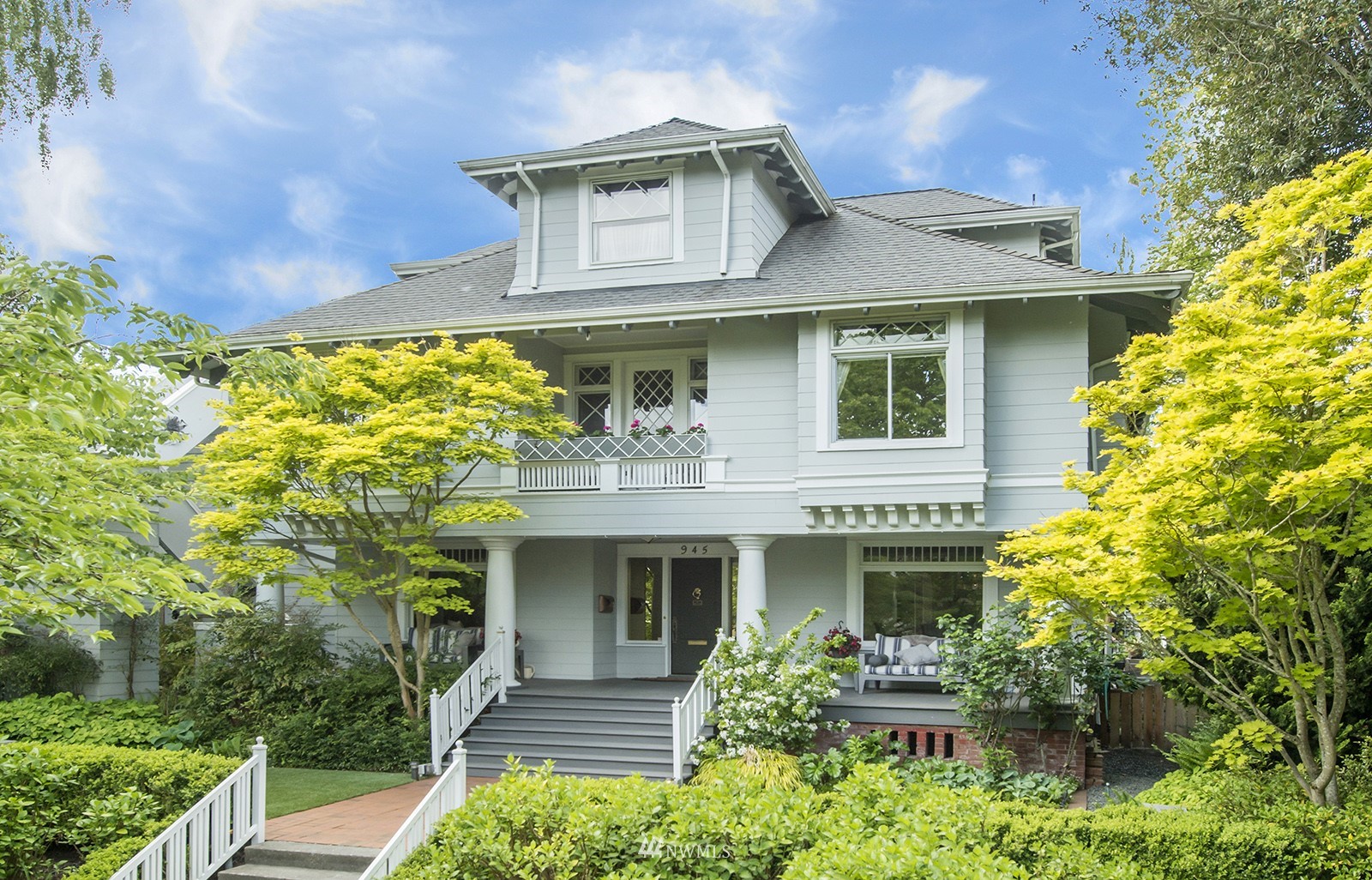 a front view of a house with plants