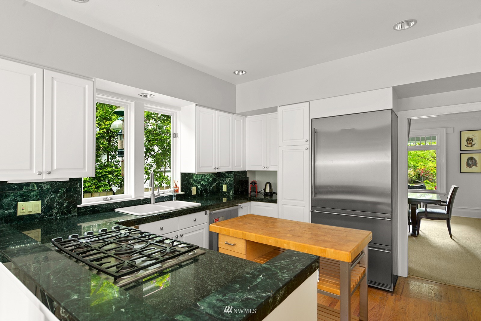 945 17th Avenue East Seattle, WA 98112 - Photo 15 of 40 a kitchen with stainless steel appliances granite countertop a stove a sink and a refrigerator