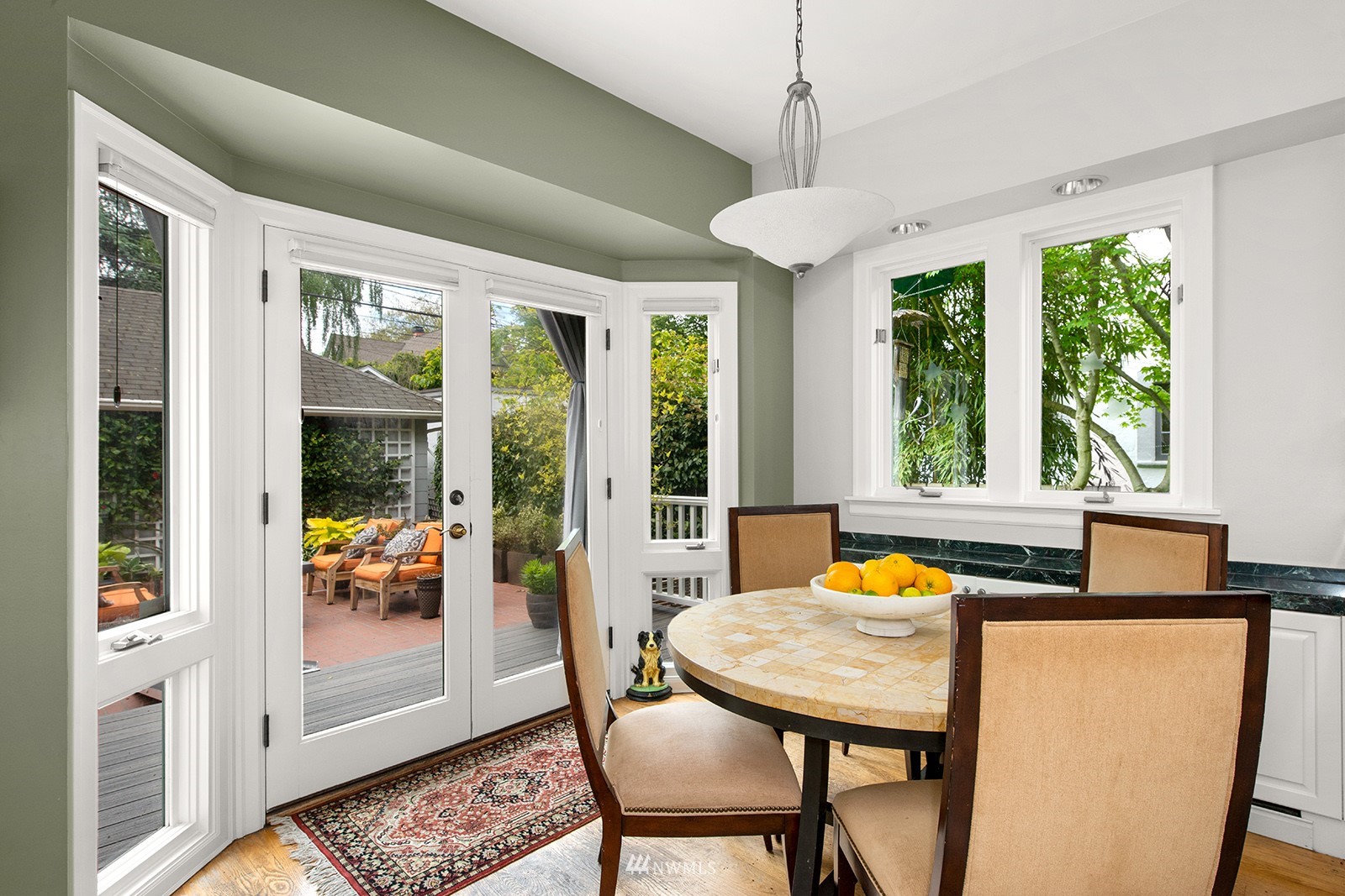 945 17th Avenue East Seattle, WA 98112 - Photo 16 of 40 a view of a dining room with furniture large windows and wooden floor