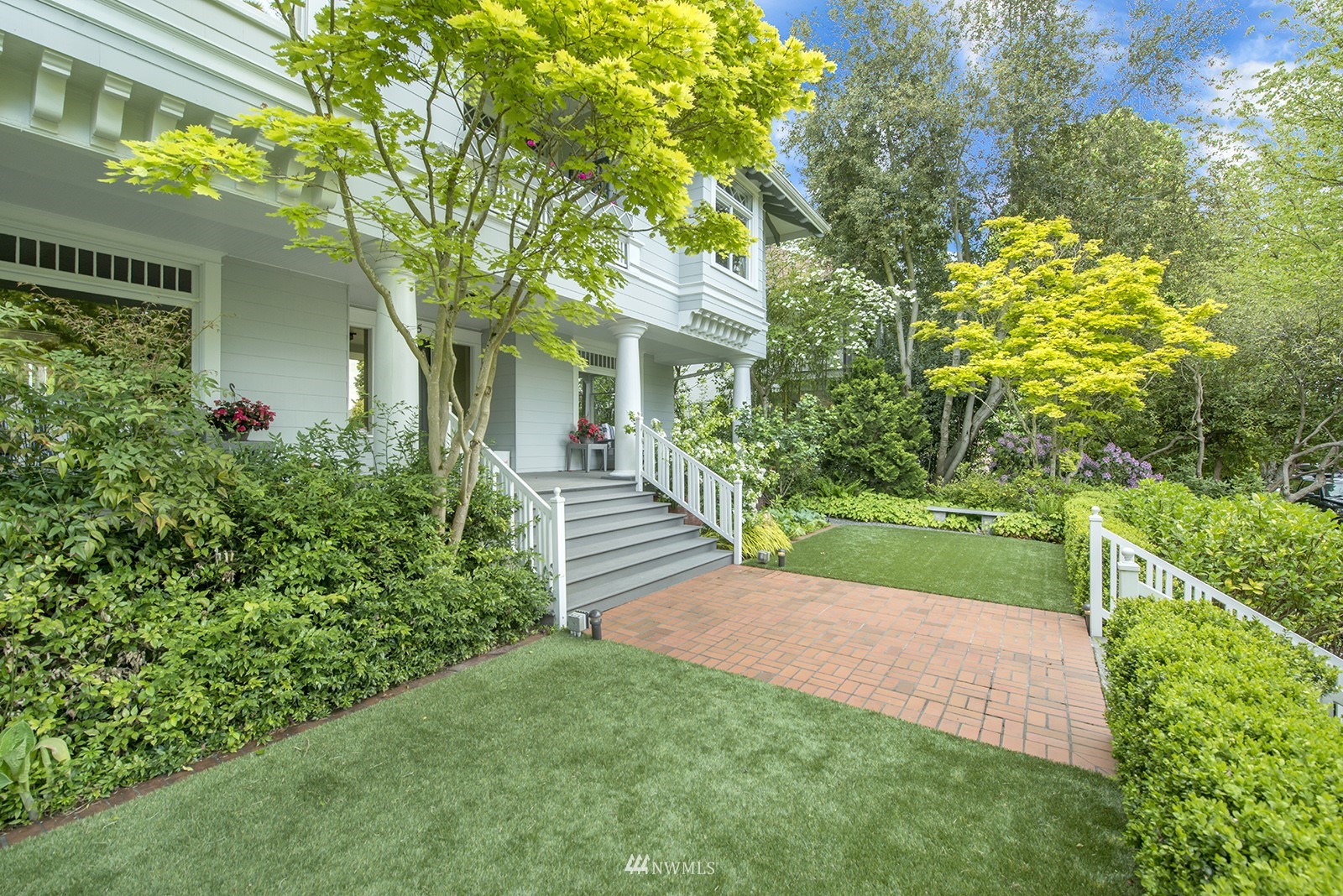 945 17th Avenue East Seattle, WA 98112 - Photo 3 of 40 a view of a yard with potted plants and large trees