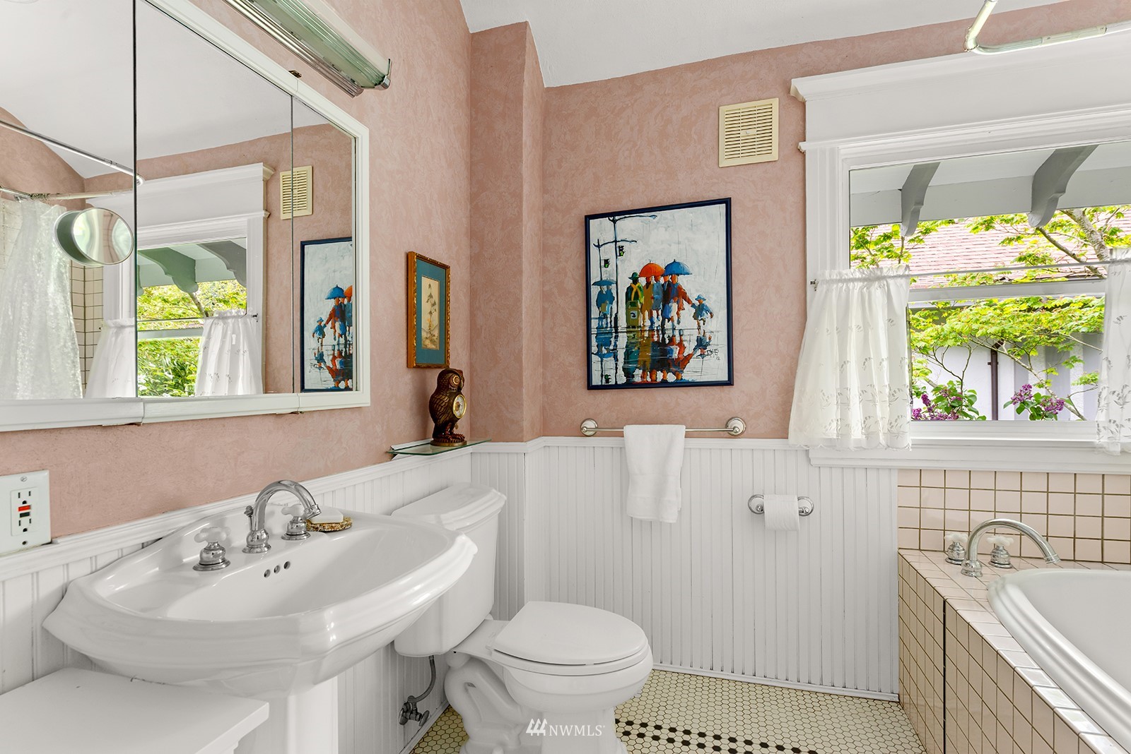 945 17th Avenue East Seattle, WA 98112 - Photo 32 of 40 a bathroom with a sink a toilet and a mirror
