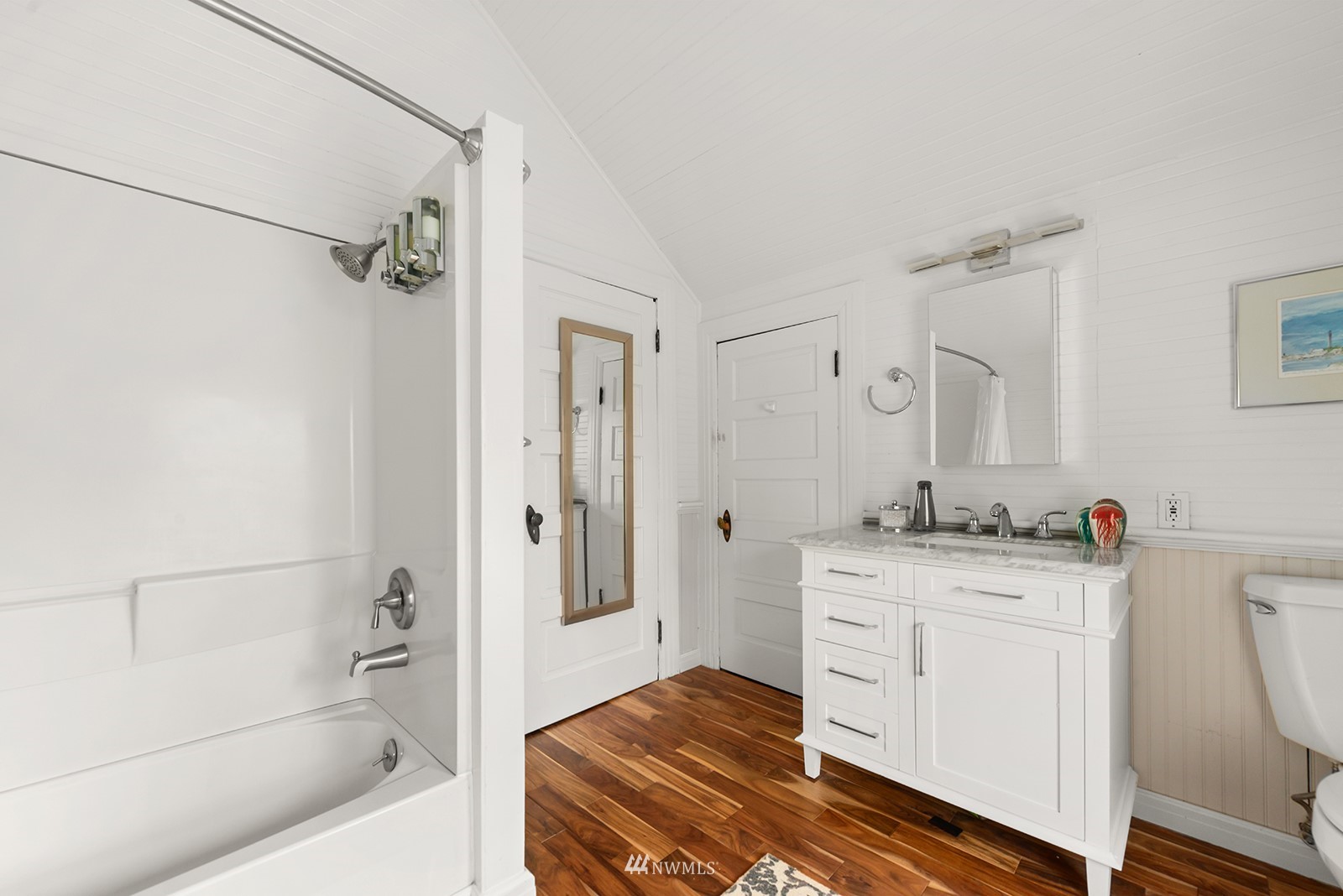 945 17th Avenue East Seattle, WA 98112 - Photo 35 of 40 a bathroom with a granite countertop sink a toilet and shower
