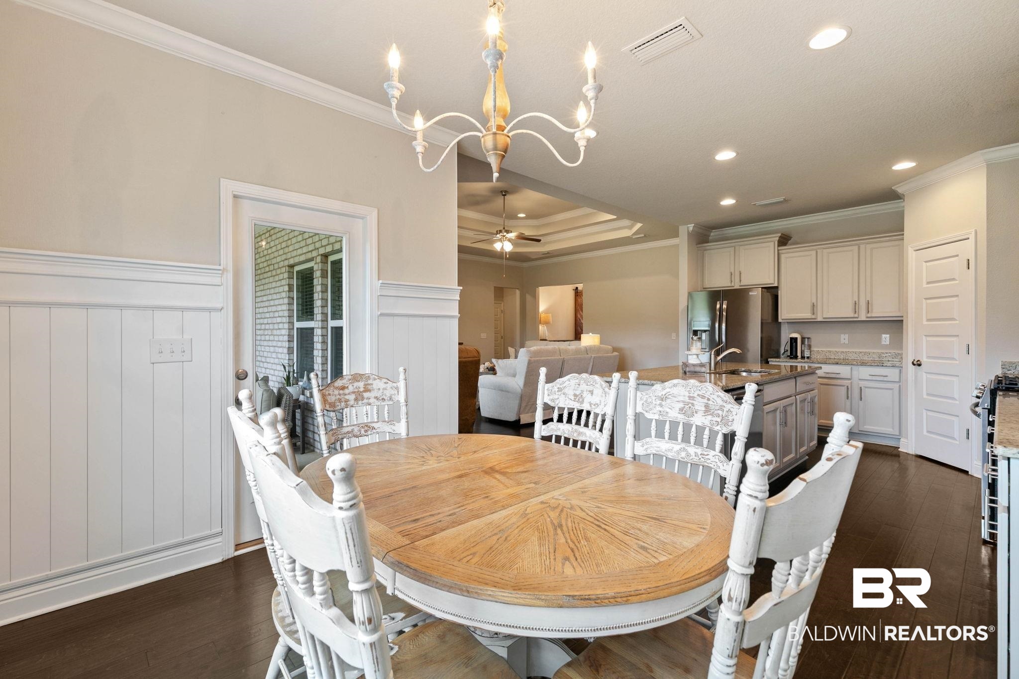 31187 Spoonbill Road Daphne, AL 36527 - Photo 20 of 85 Hardwood-style flooring throughout the open-concept living space, featuring wainscoting details, crown molding, and recessed lighting