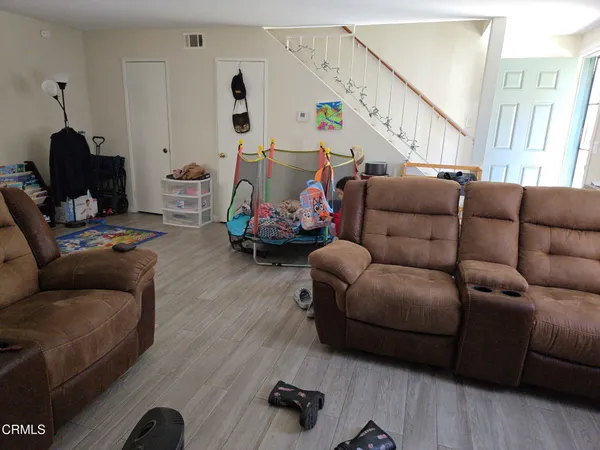 a bedroom with furniture and a wooden floor