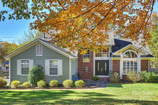 a front view of a house with a garden and plants