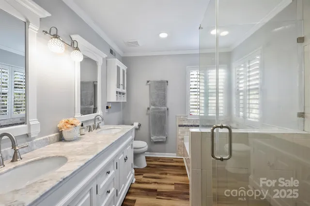 a bathroom with a granite countertop bathtub sink vanity and mirror
