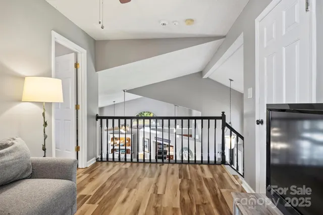 a bedroom with a bed wooden floor and window
