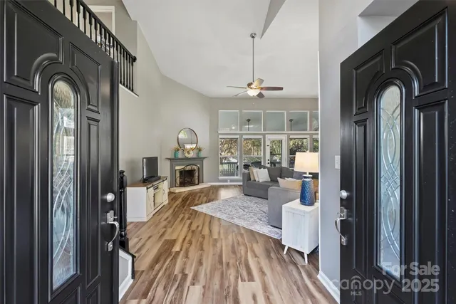 a view of living room and kitchen with wooden floor