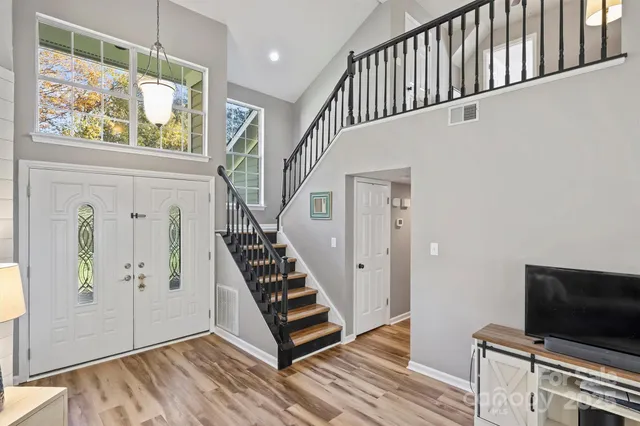 a view of an entryway with wooden floor and stairs