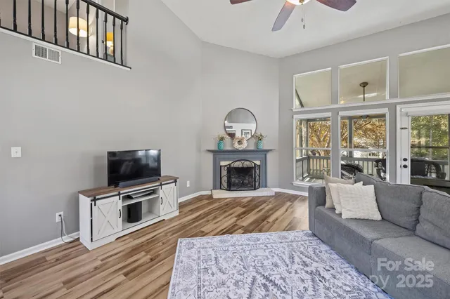 a living room with furniture a fireplace and a flat screen tv
