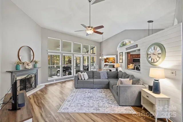 a living room with furniture a clock and a fireplace