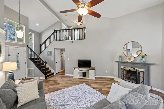 a living room with furniture a flat screen tv and a fireplace