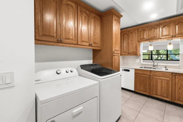 a kitchen with a sink a stove and cabinets
