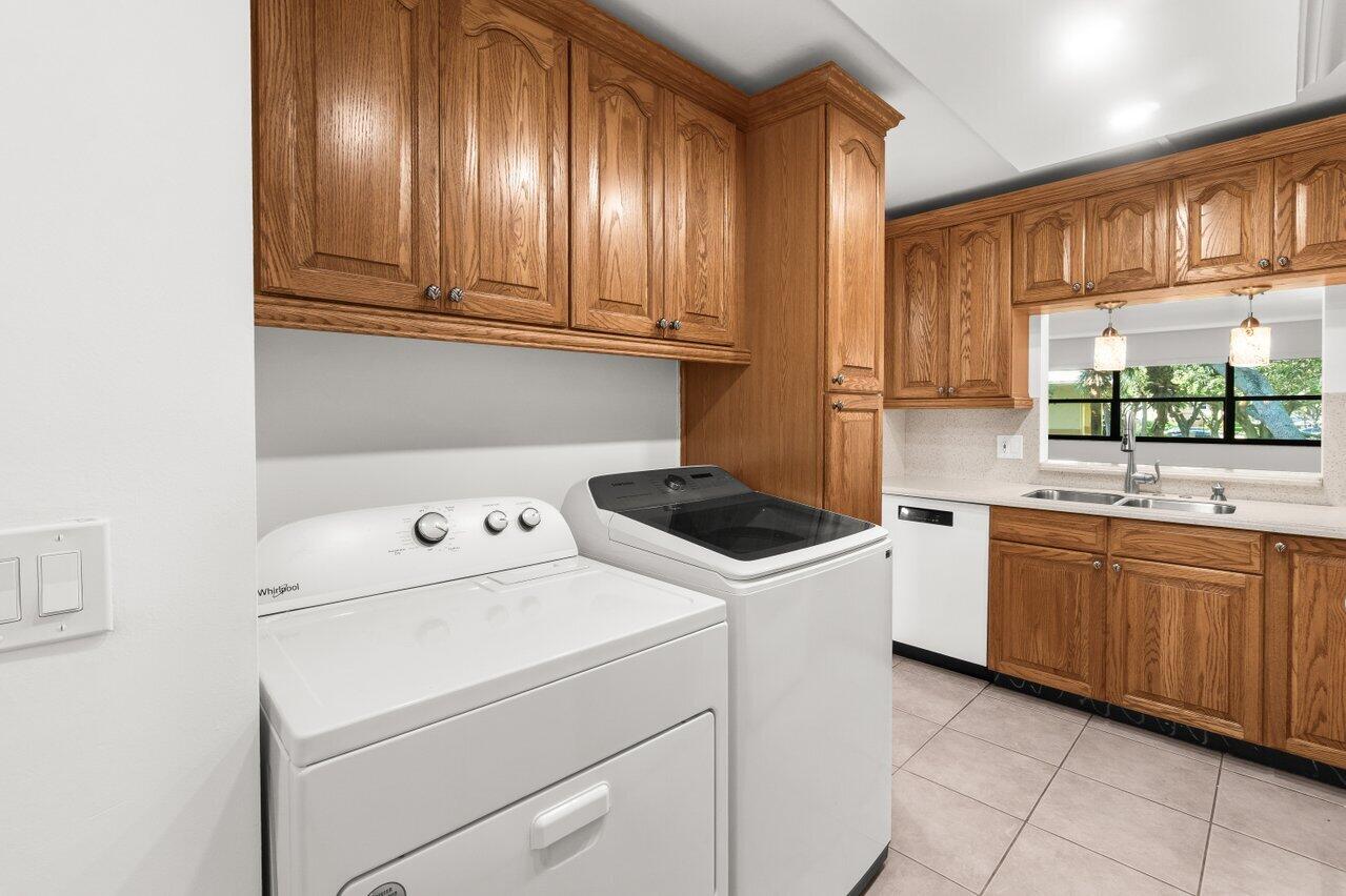 3014 Southwest 21st Terrace, Unit 352B Delray Beach, FL 33445 - Photo 11 of 26 a kitchen with a sink a stove and cabinets