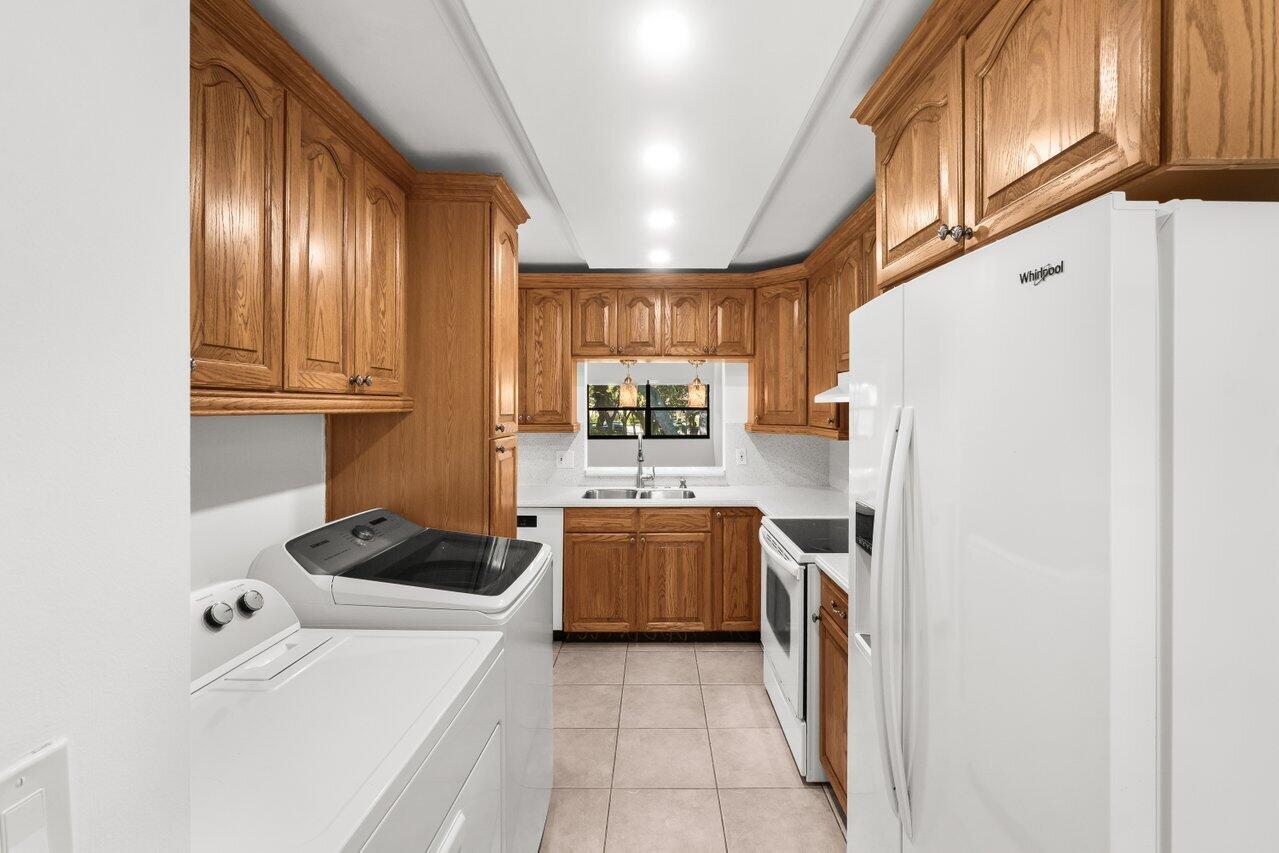 3014 Southwest 21st Terrace, Unit 352B Delray Beach, FL 33445 - Photo 12 of 26 a kitchen with a refrigerator and a stove
